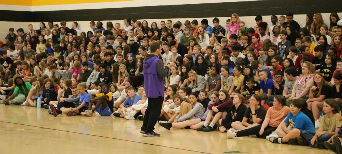 Wrestling coach Doug Schwab speaks to sixth graders
