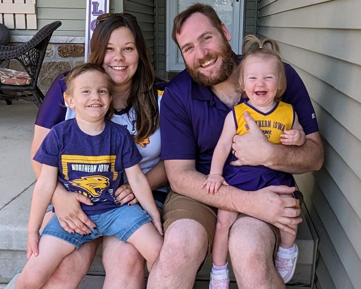 Michael Linde, his wife, and their two young children, all in Panther gear