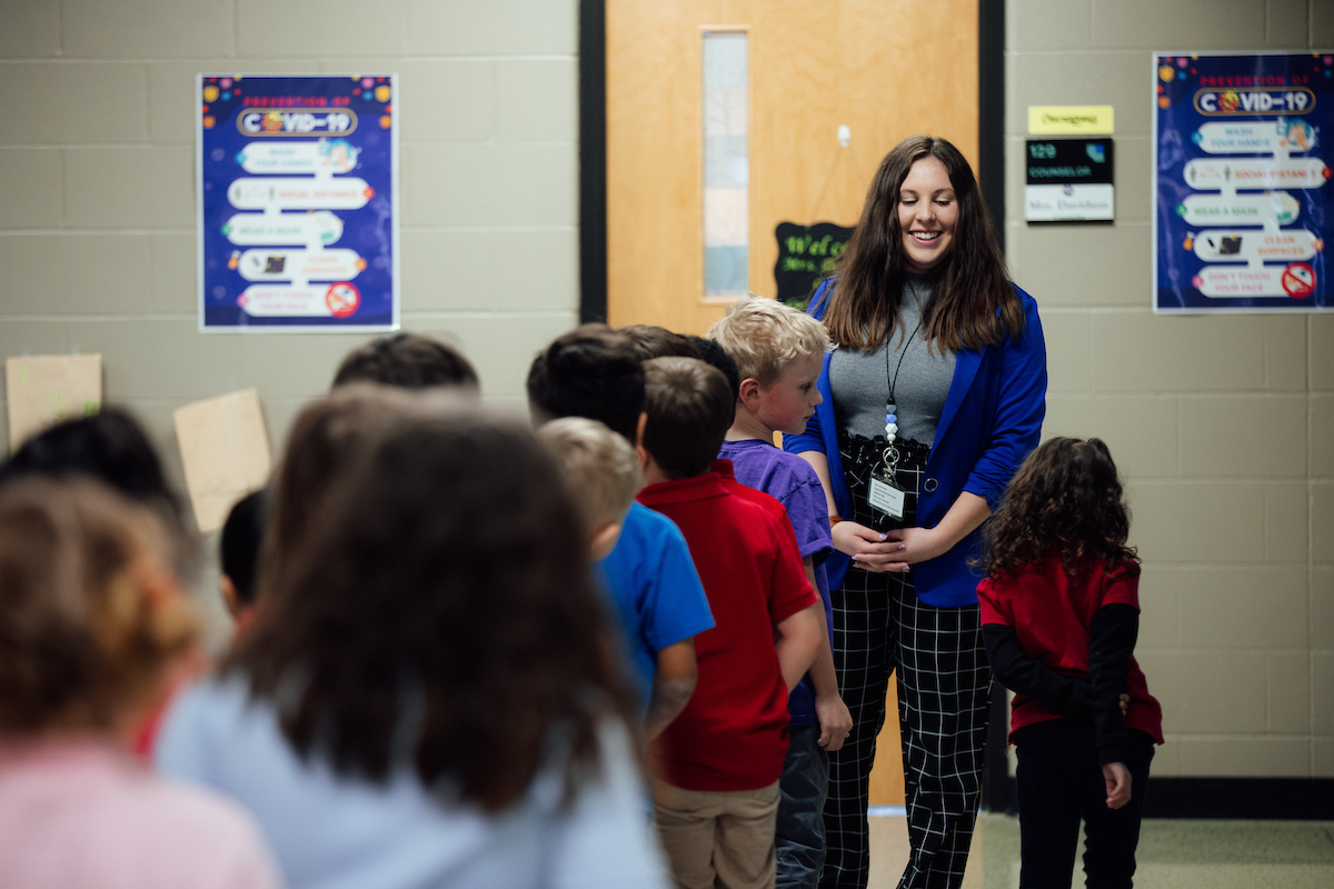 Teacher in front of line of students