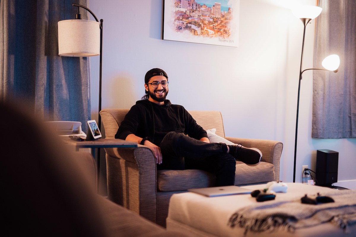 Umar Chohan sitting in armchair, smiling