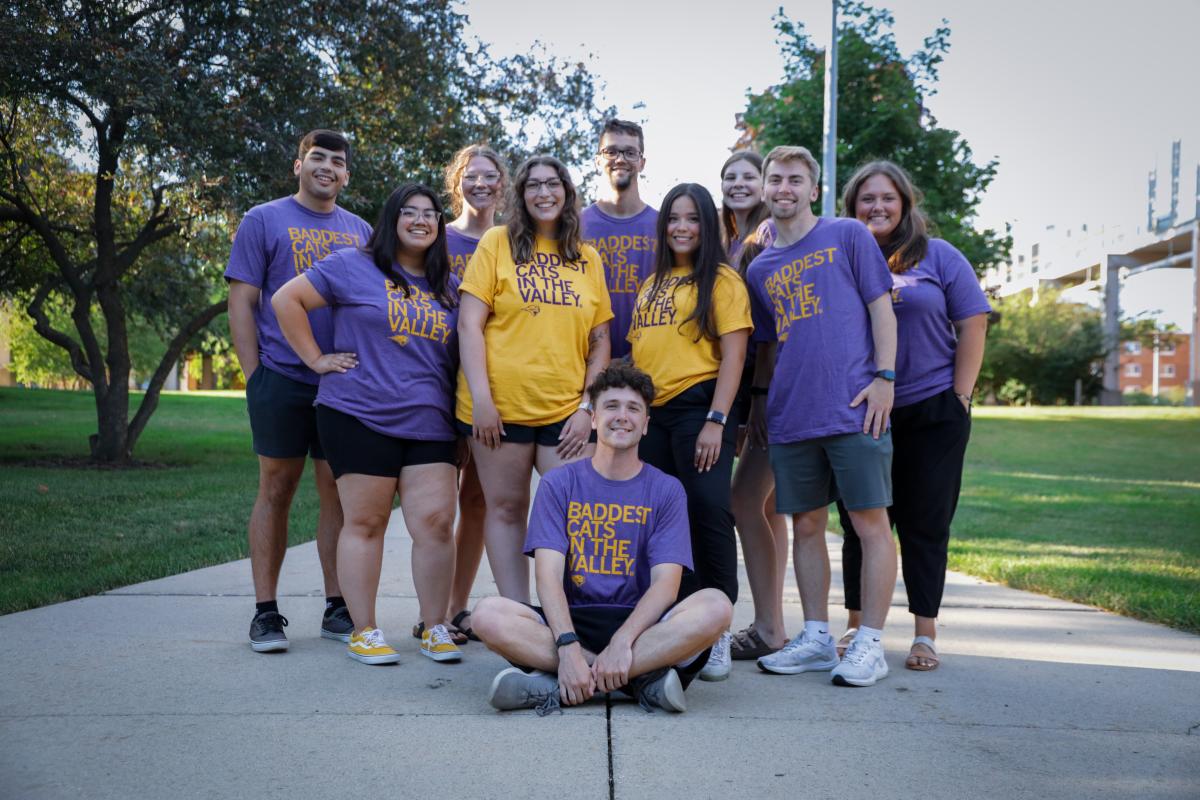 UNI students wearing Baddest Cats in the Valley t-shirts in purple and gold