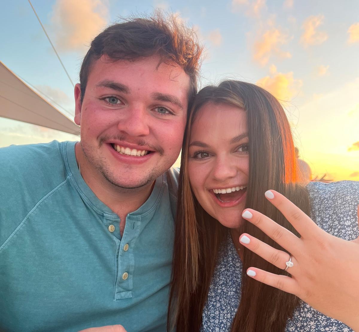 Ethan Arnold and Mallory Burdt, with Mallory showing off her engagement ring