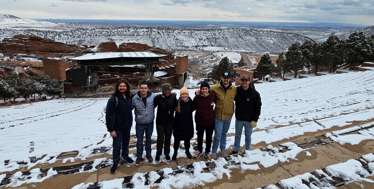 Seven UNI geography students standing in front of Red Rock Ampitheater