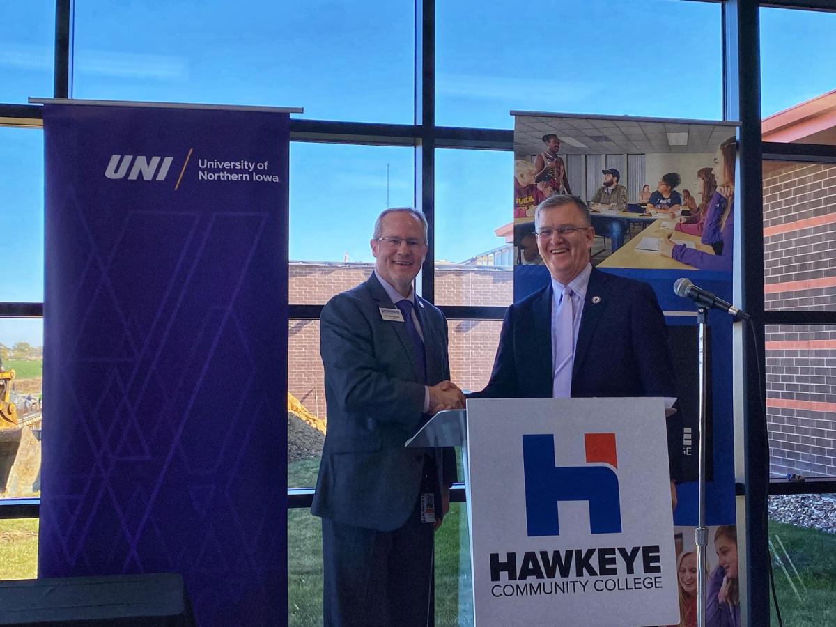 Hawkeye Community College President Todd Holcomb and UNI President Mark Nook shaking hands