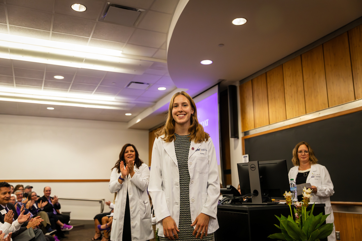 UNI student wearing white coat