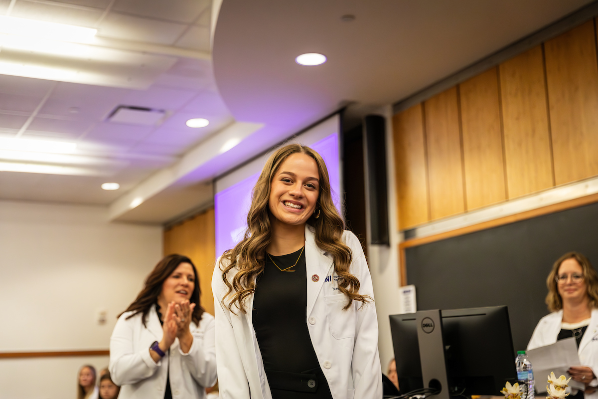 UNI student wearing white coat