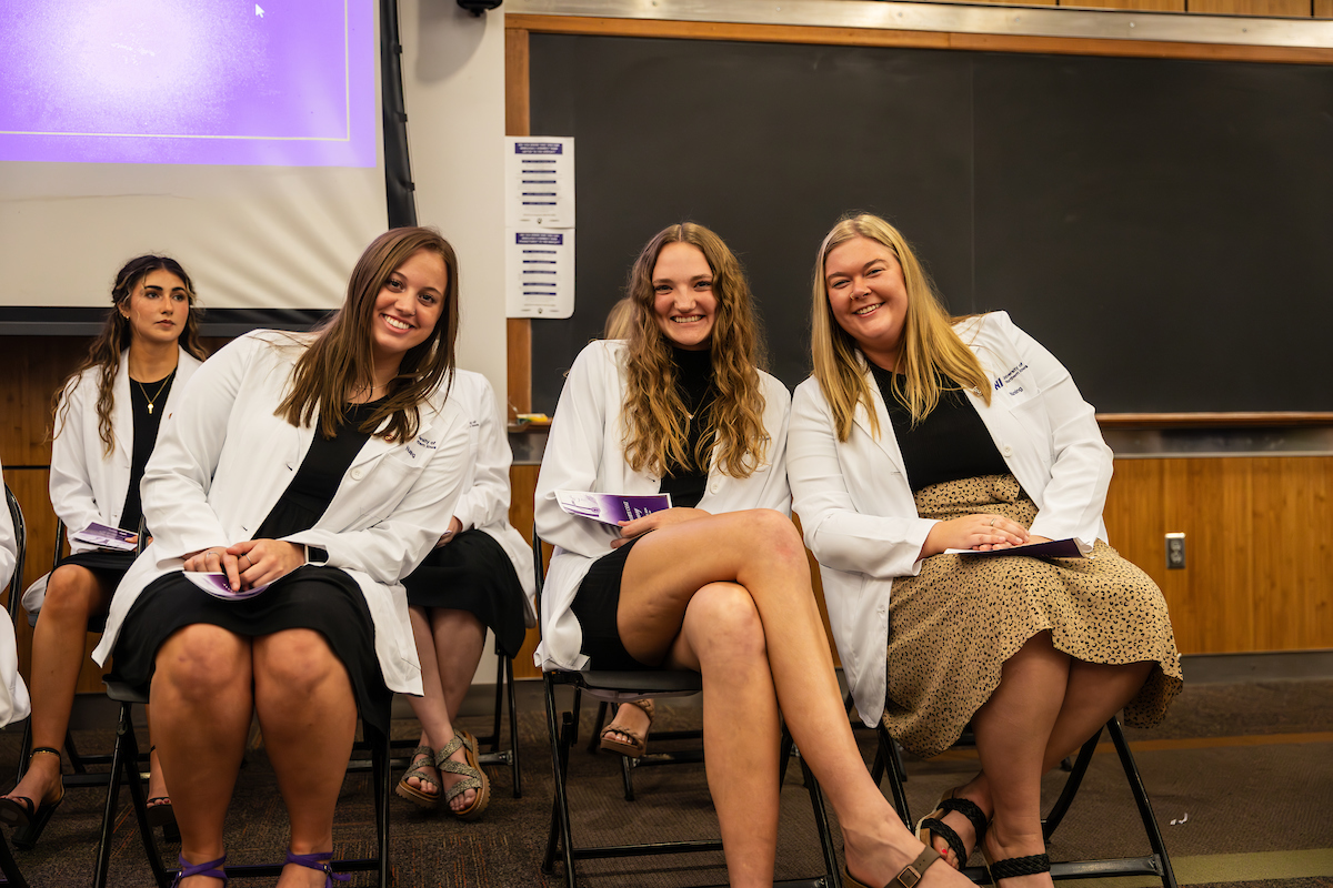 UNI students wearing their white coats at White Coat Ceremony