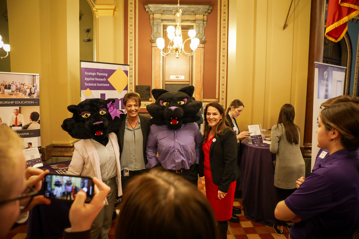 People pose for photos with TC and TK at UNI Day at the Capitol