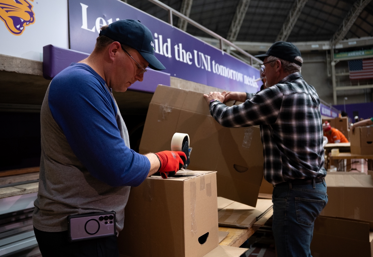 Pack the Dome volunteers seal boxes