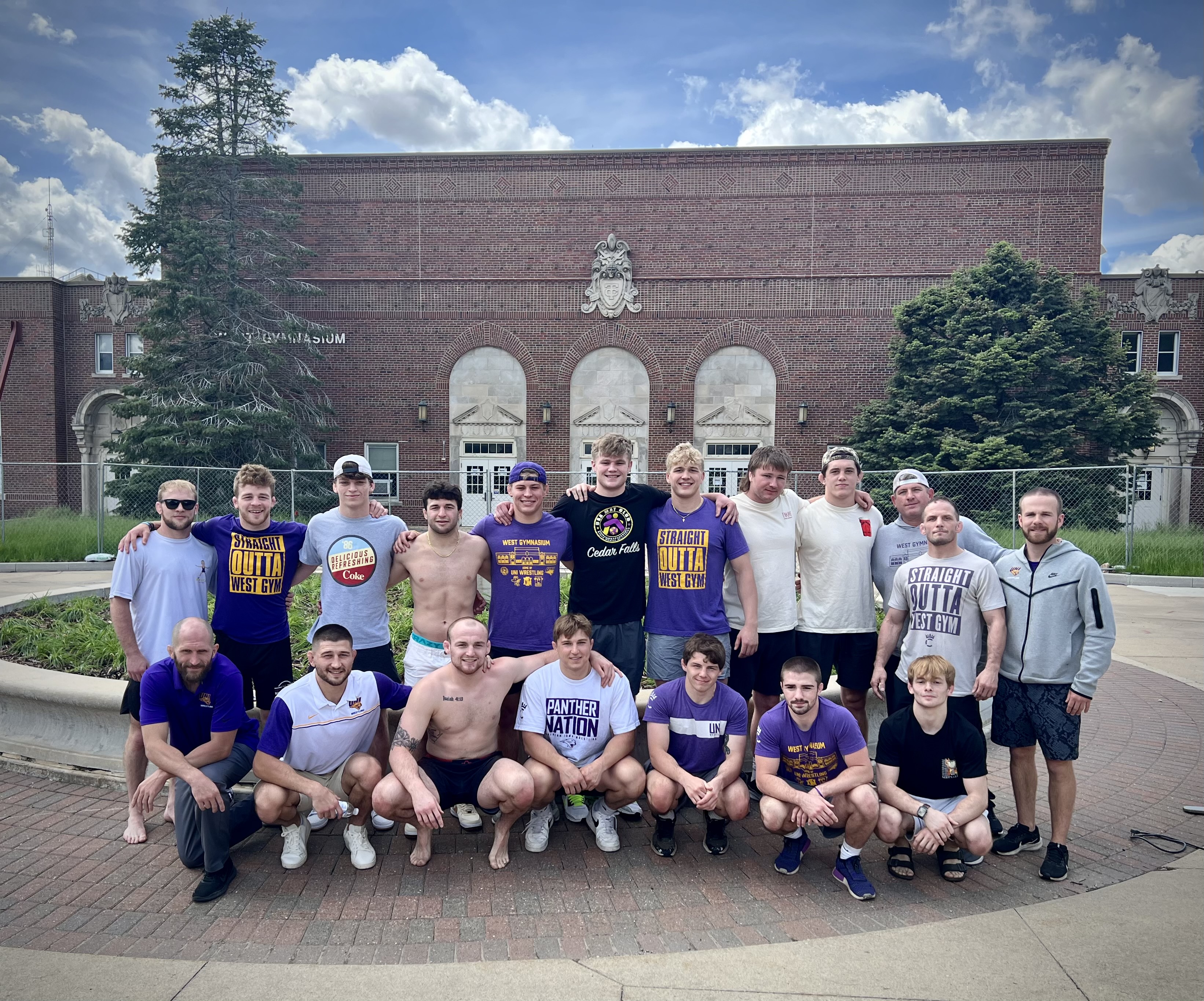Panther wrestlers in front of the West Gym with Coach Schwab
