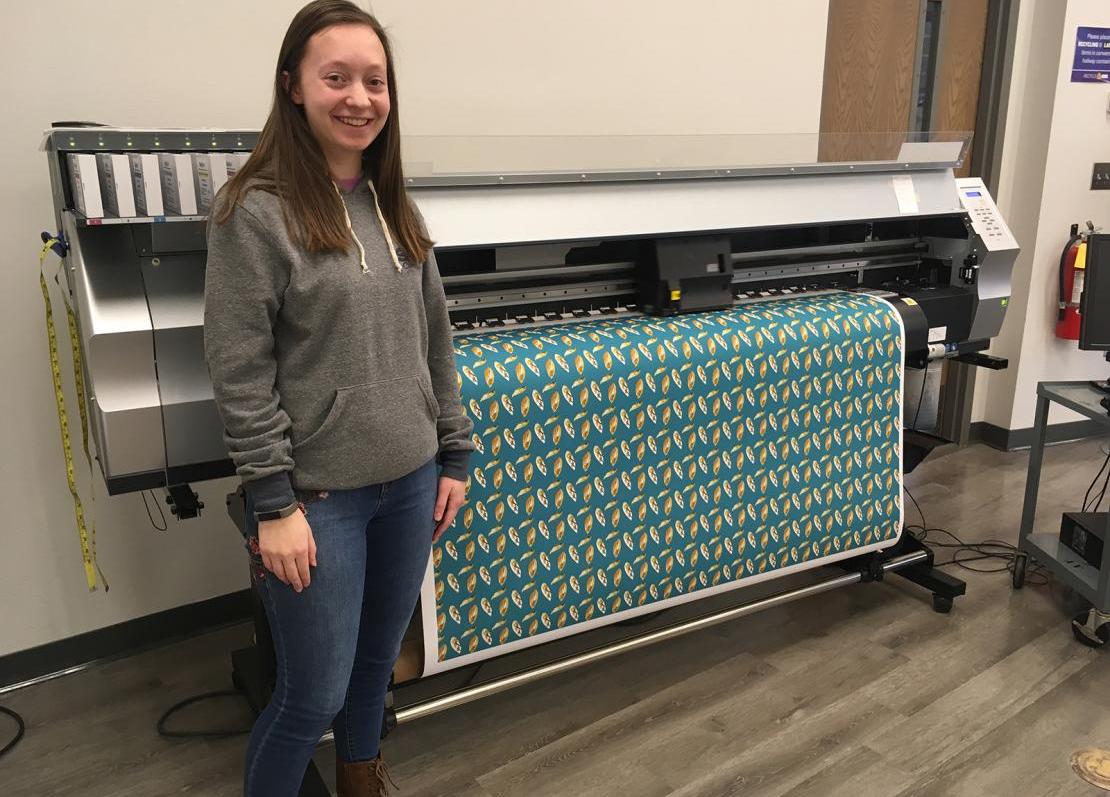  UNI senior Rachel Funkhouser printing off a piece of fabric.