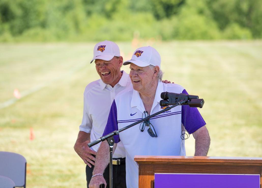 UNI football coach Mark Farley shares a laugh with Doug Goschke.
