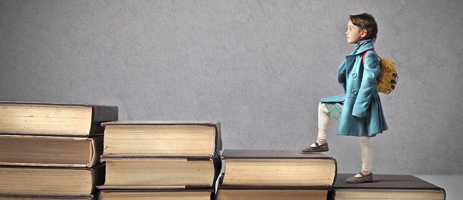 A child stepping on giant books.