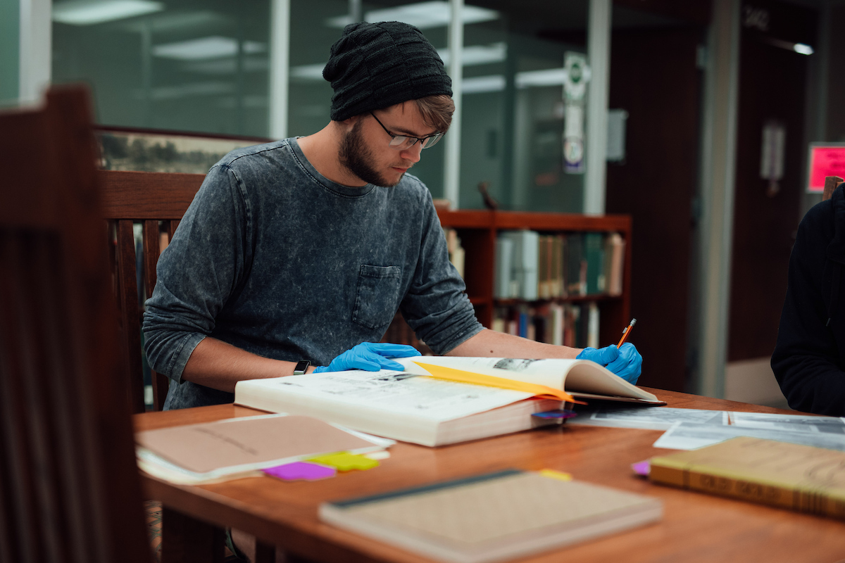 Student looking through archives in Rod Library