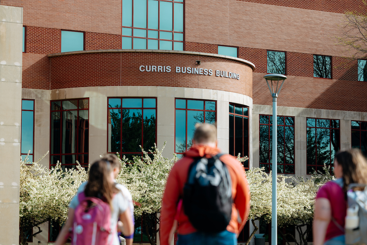 Students walking toward Curris Business Building