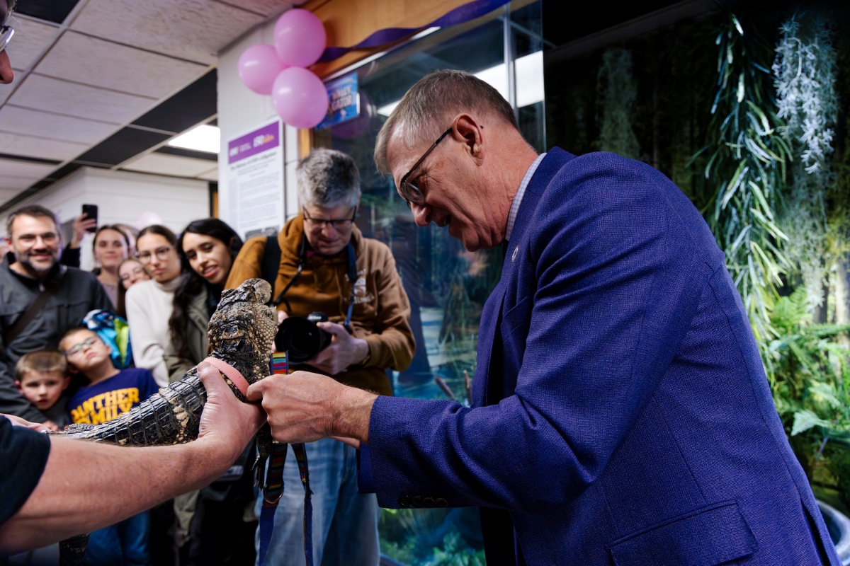 President Nook petting Wally the alligator