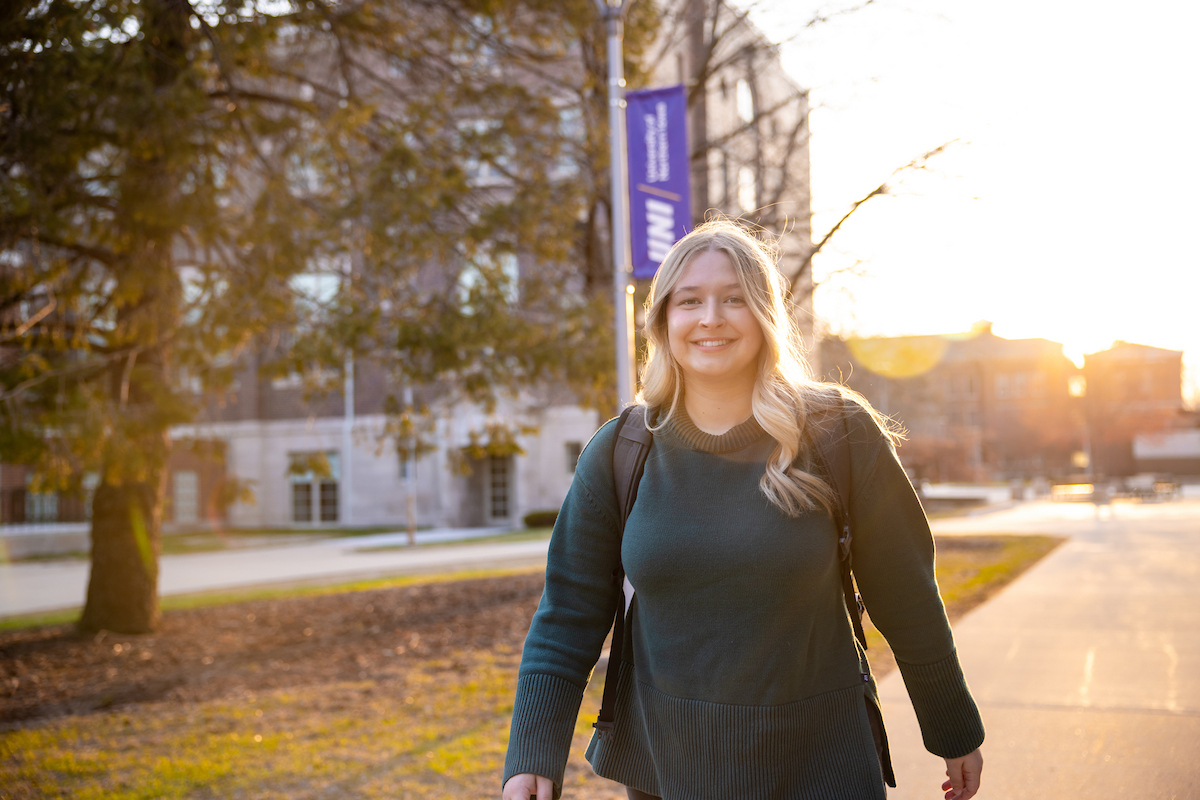 Student walking on UNI campus