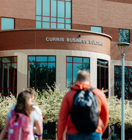 Students walking toward Curris Business Building