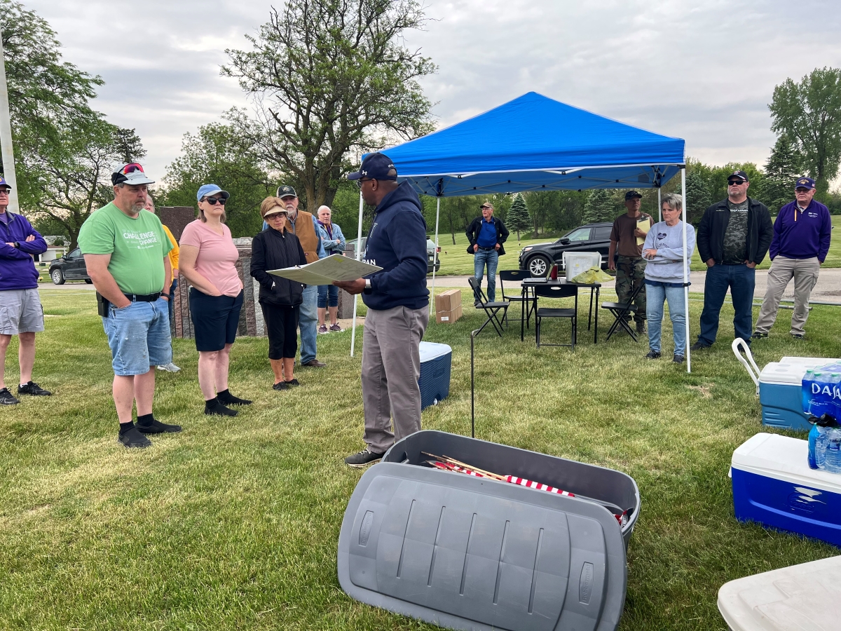 Volunteers gather to place flags at Garden of Memories Cemetery