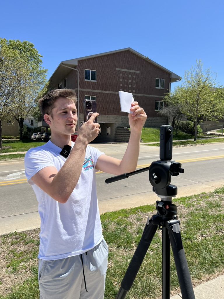 Zach Rogers taking photo on phone of historic UNI image