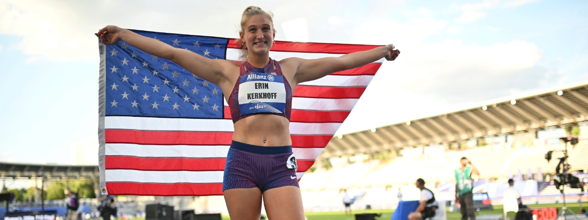 Erin Kerkhoff on race track holding up American flag