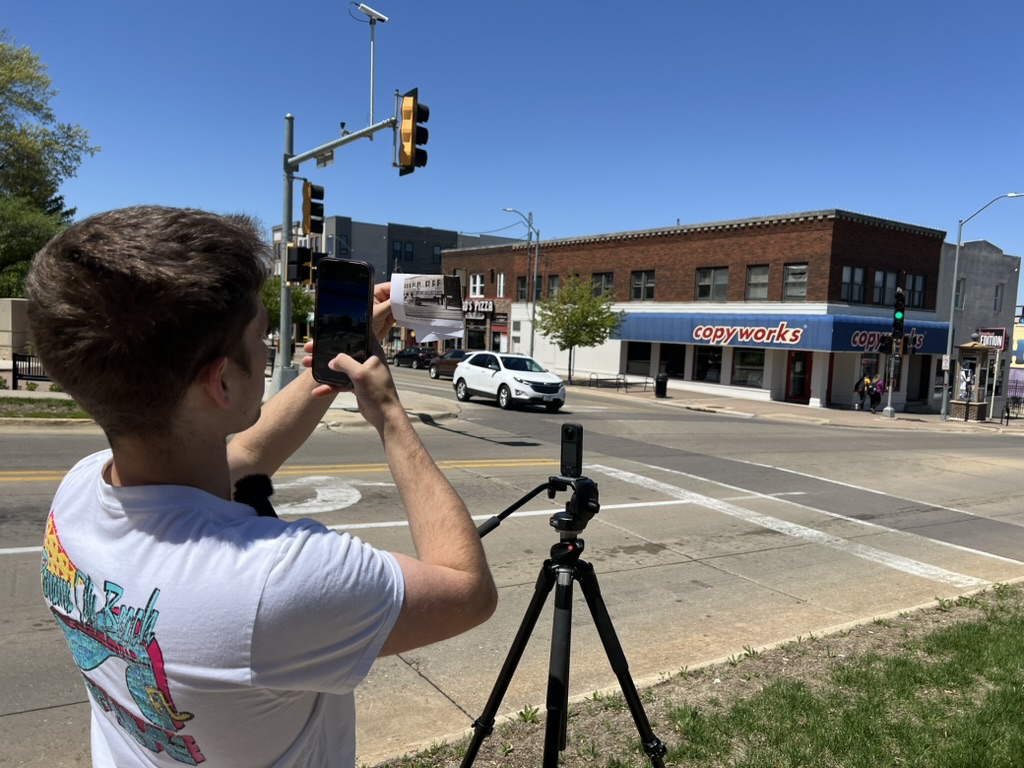 Zach Rogers on College Hill taking a photo of a historic photo