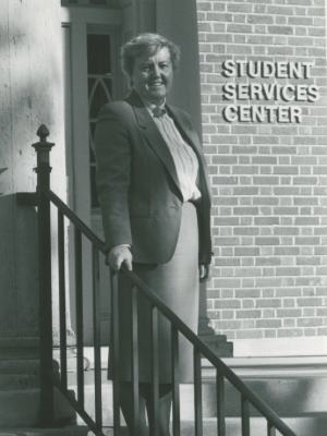 Sue Follon standing in front of the Student Services Center on UNI campus