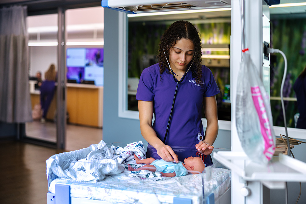 Student practicing on a synthetic patient.
