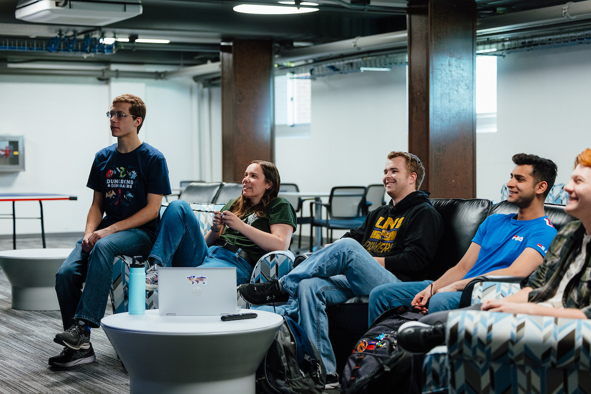 Students playing video games together in residence hall