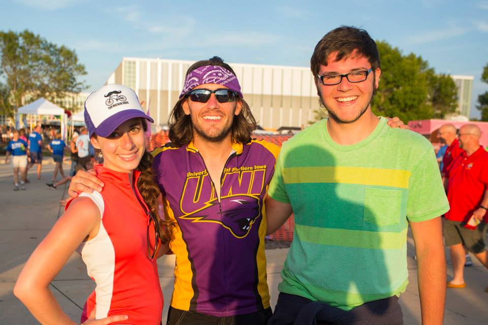 RAGBRAI participants smiling, including one man wearing a UNI jersey