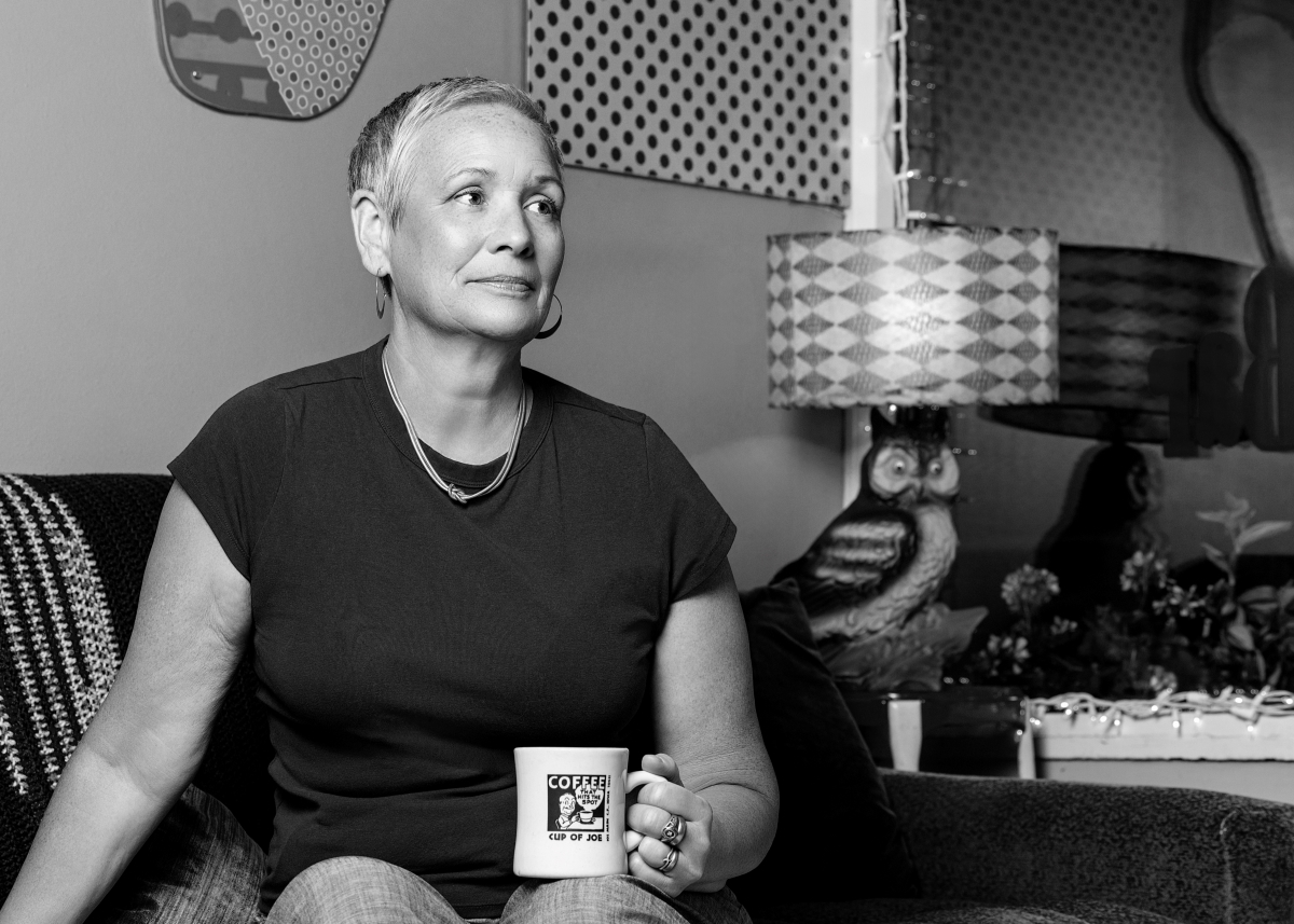 Black and white photo of Dawn Wilson at Cup of Joe with a mug