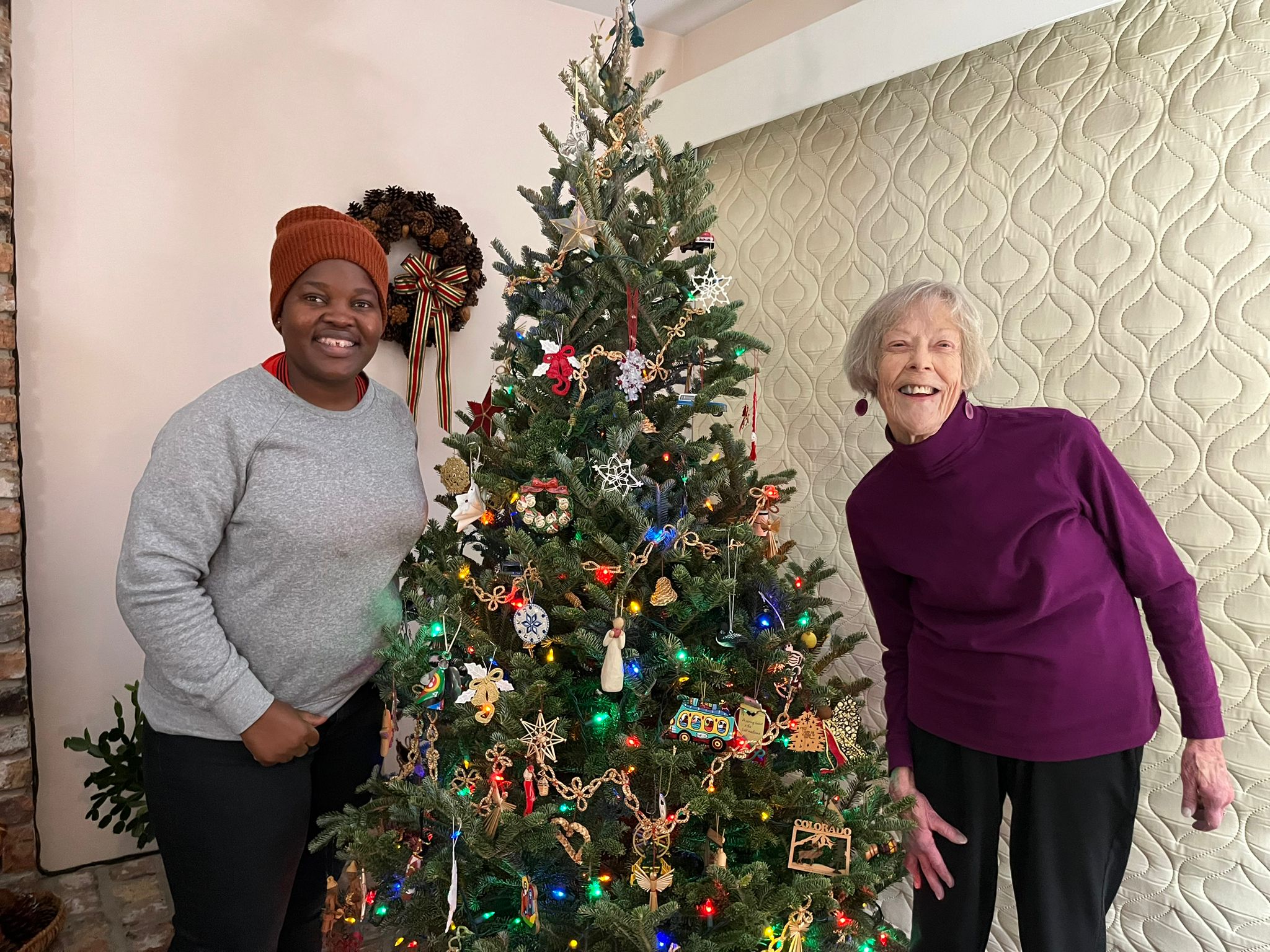 Plaxcedes Mawora and Margie Keiser with decorated Christmas tree