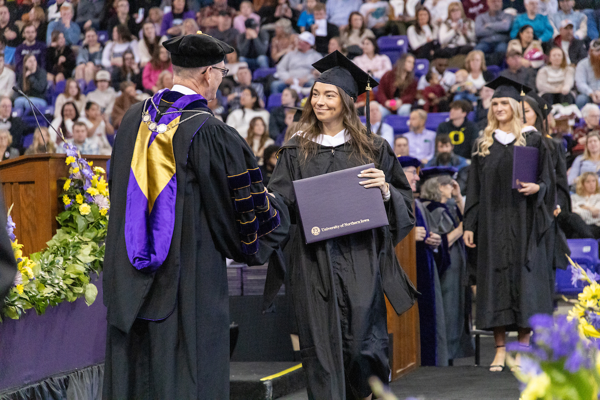 Graduate walks across the stage at UNI Commencement