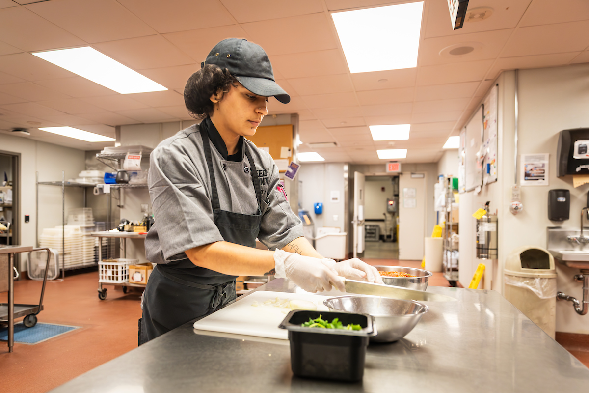 Isabella Carrillo chopping vegetables