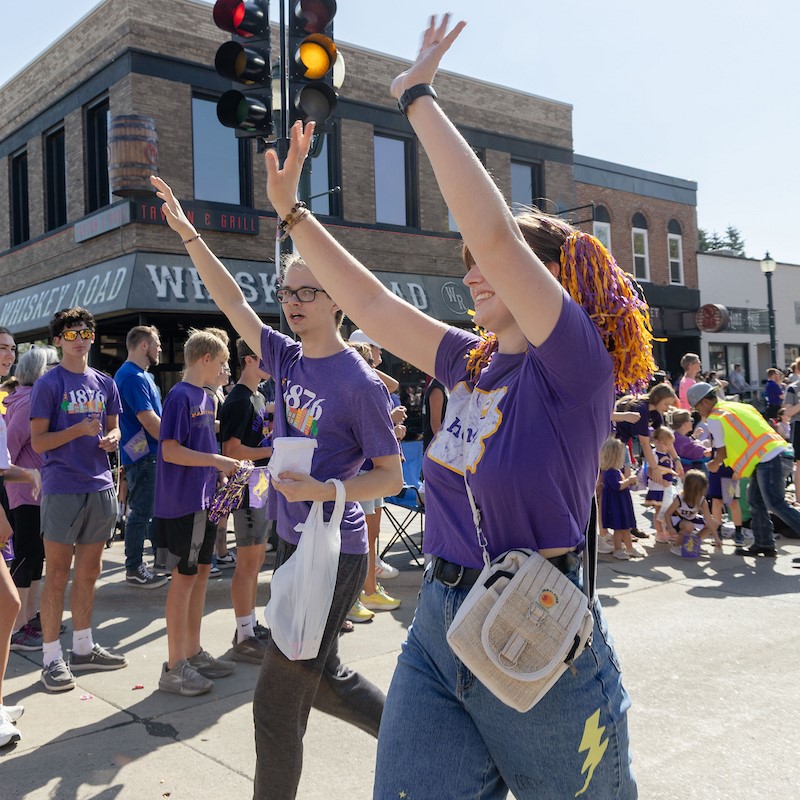 People in purple at UNI Homecoming Parade