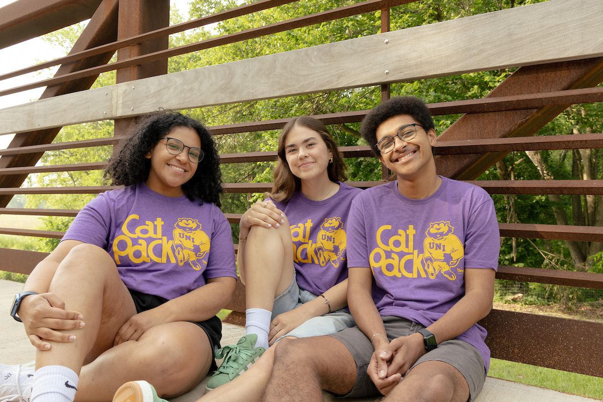 Students on bridge wearing Cat Pack t-shirts