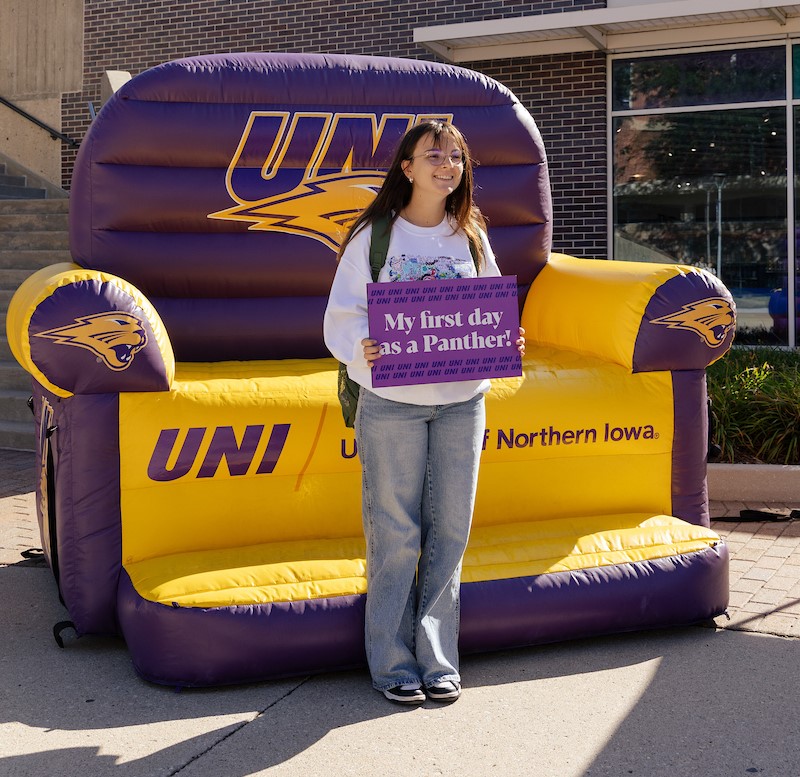 Student holding a "My first day as a Panther" sign