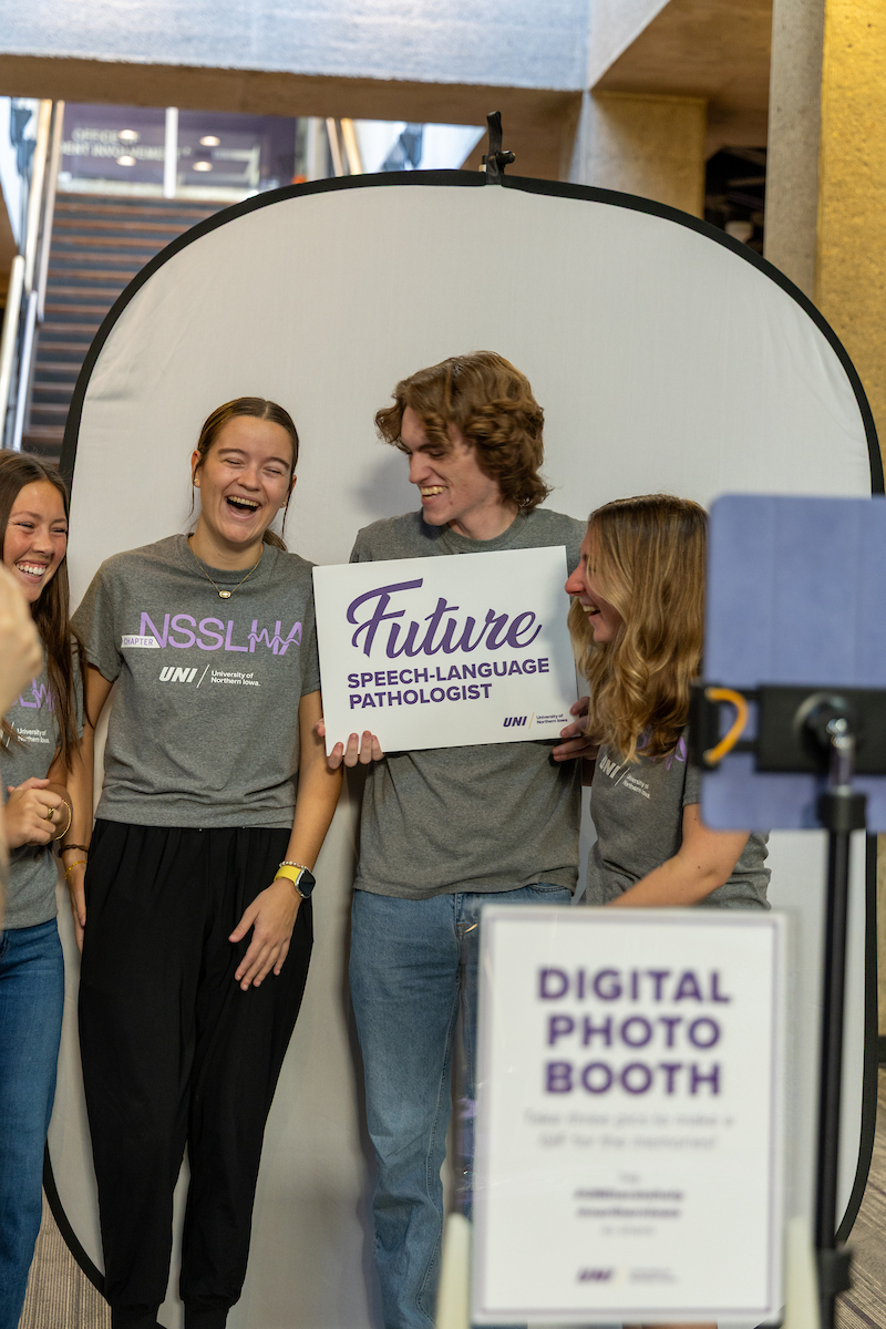 Students holding up "Future speech-language pathologist" sign