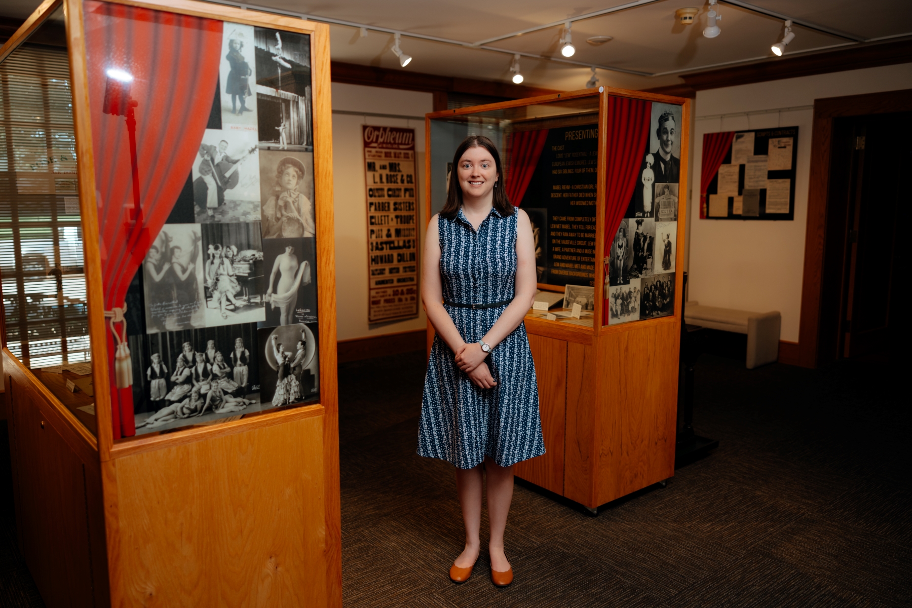 UNI alum standing next to history exhibit