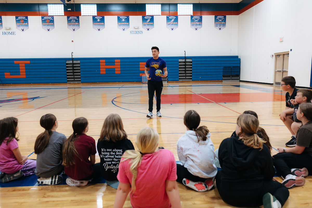 PE teacher giving instructions to students