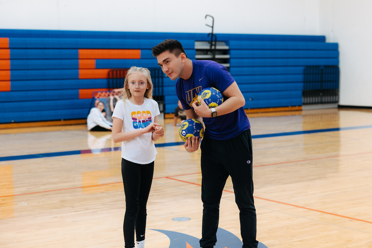 PE teacher working with student