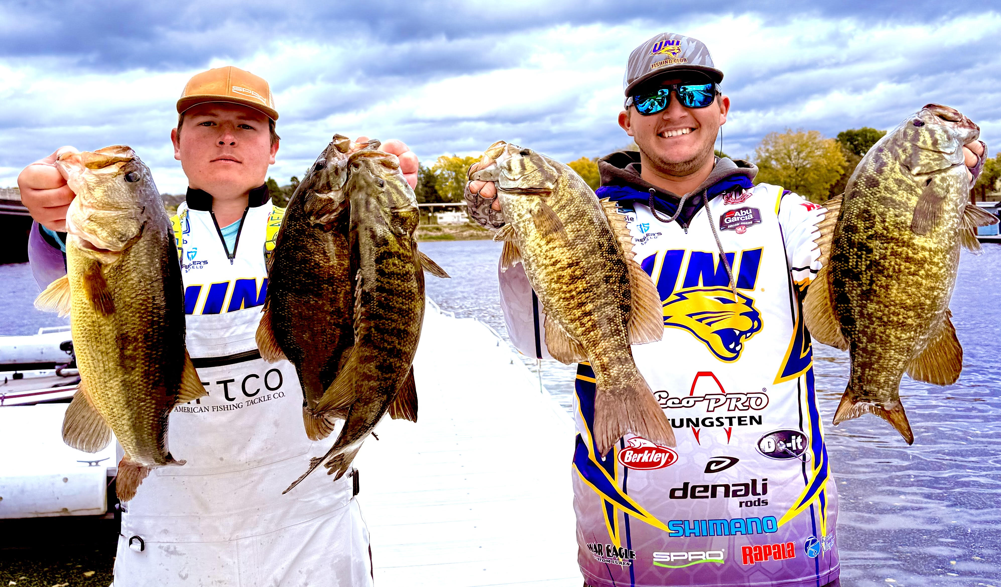 Jacob Lange and Cole Siebenahler out on the water, holding up caught fish