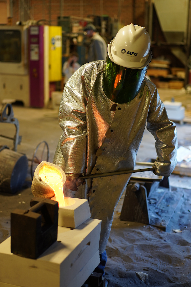 UNI student pouring molten metal in UNI Metal Casting Center