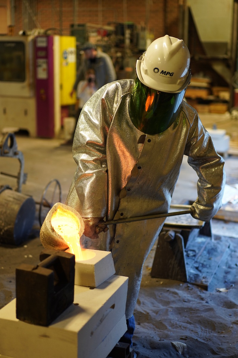 UNI student pouring metal in Metal Casting Center