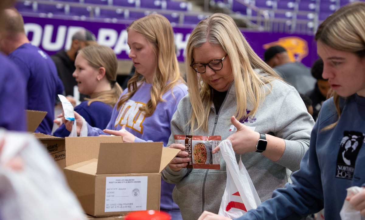 Pack the Dome volunteers packing food into bags
