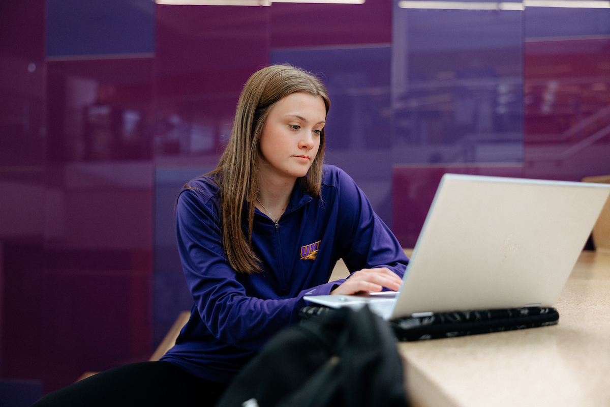 UNI student working on laptop