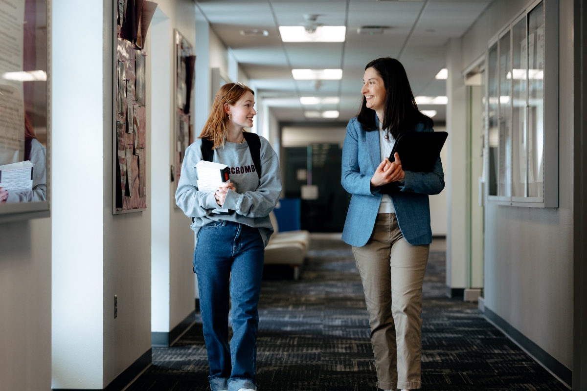 UNI professor and student walking in the hallway