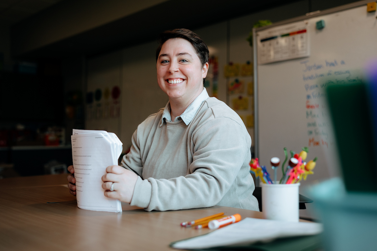 Teacher with stack of homework