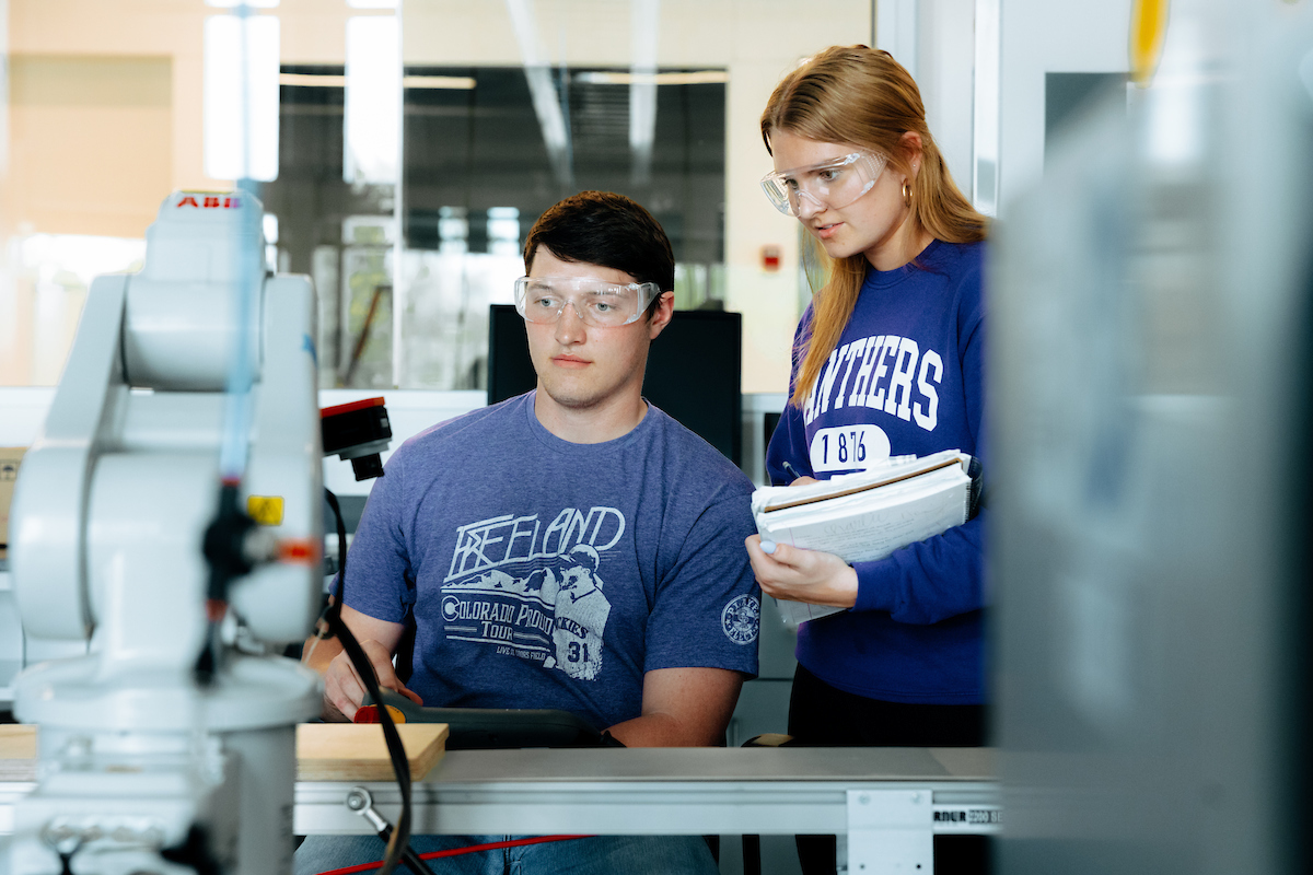 Students operating robot in Robotics Lab