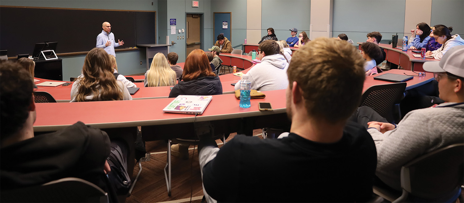 Nick Sars stands in front of classroom